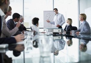 Group of office workers in a boardroom presentation